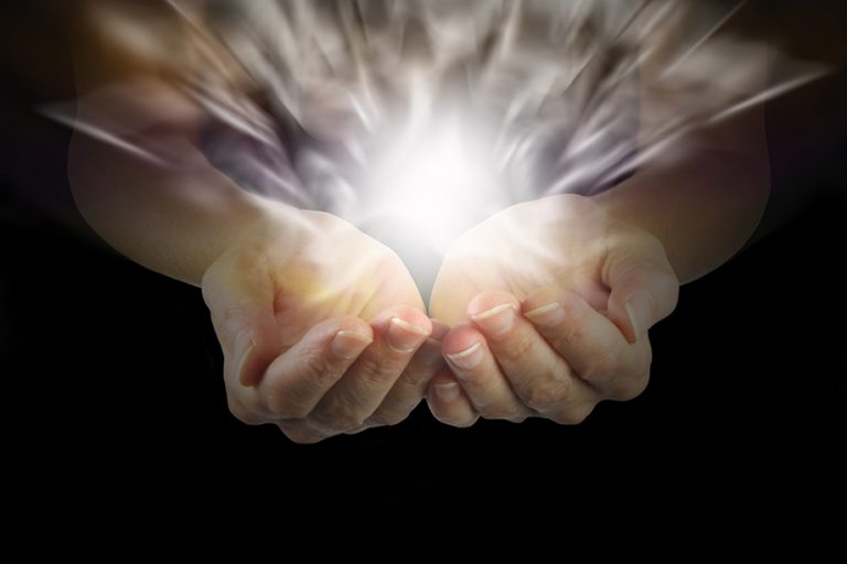 cupping hands with white light