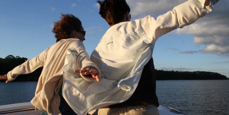 man and woman riding a boat
