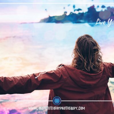 woman with arms open at beach